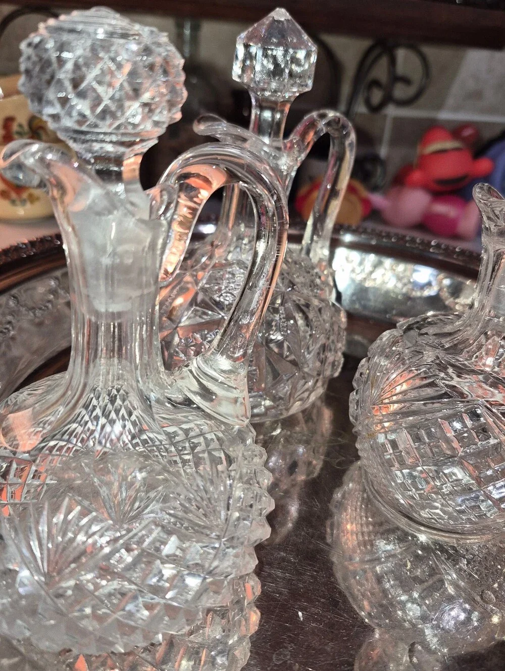3 Vintage or Antique cut-glass cruets with matching stoppers and handles